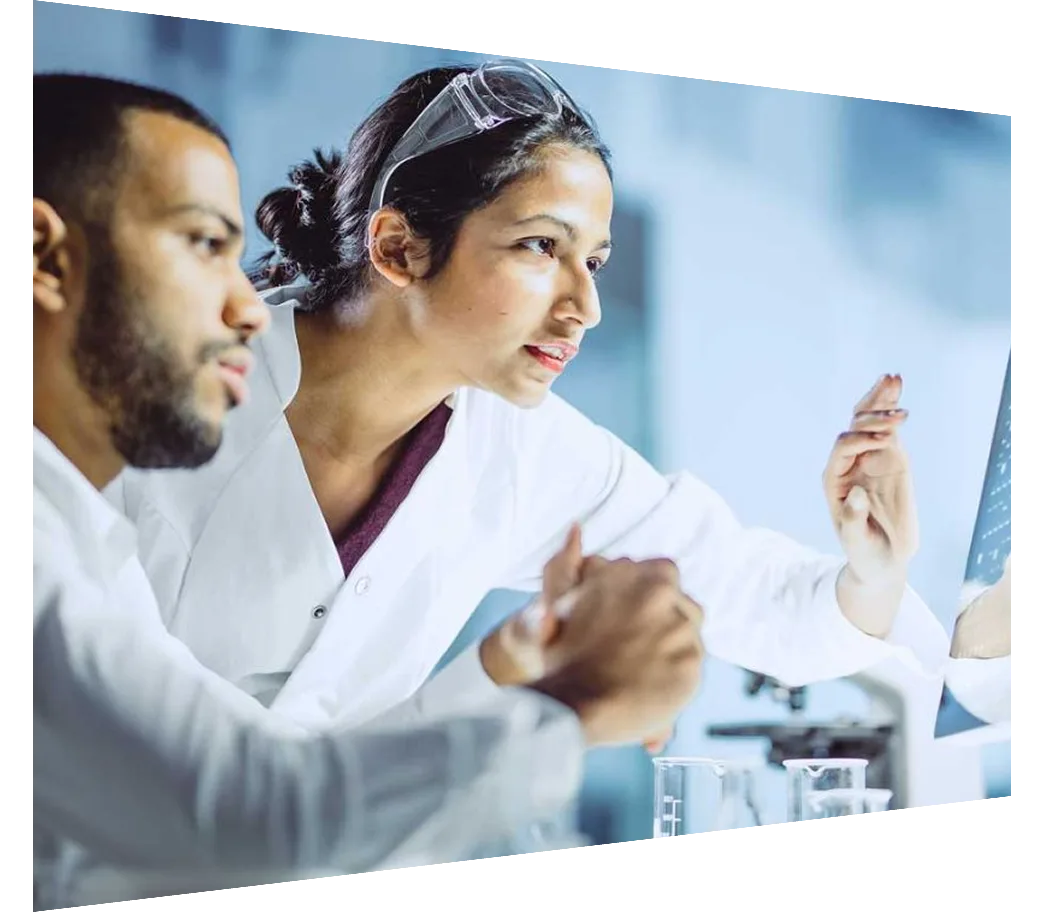 Two lab technicians collaborating on a touch-screen monitor