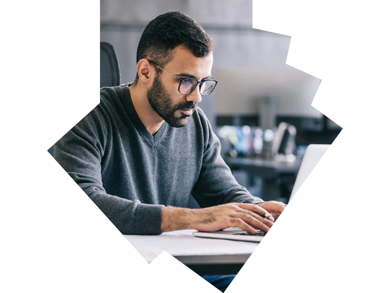 Man in sweater working at desk