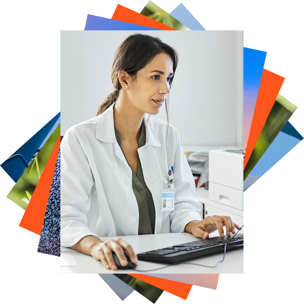Female physician in a white coat with stethoscope looks at tablet.