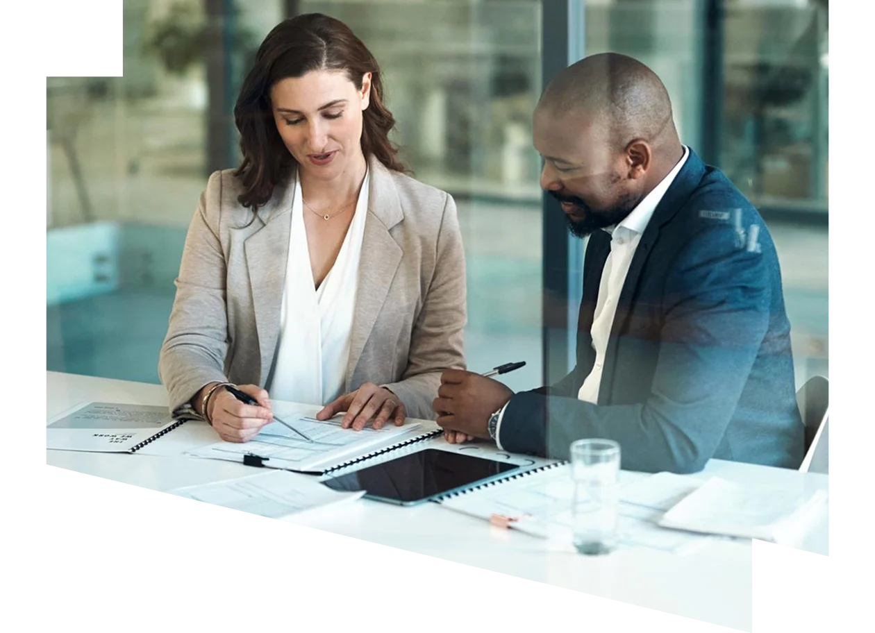 Businesswoman and business man reviewing paperwork together