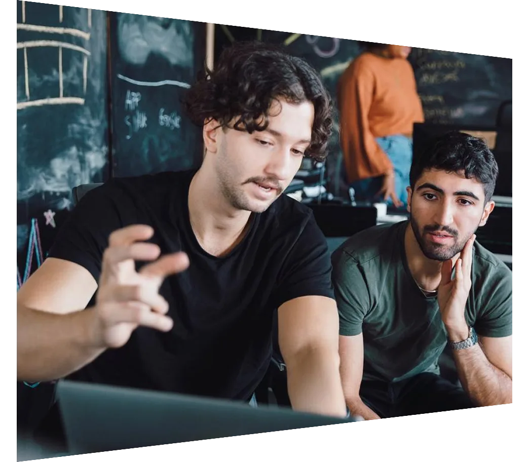 Male programmers brainstorming over laptop