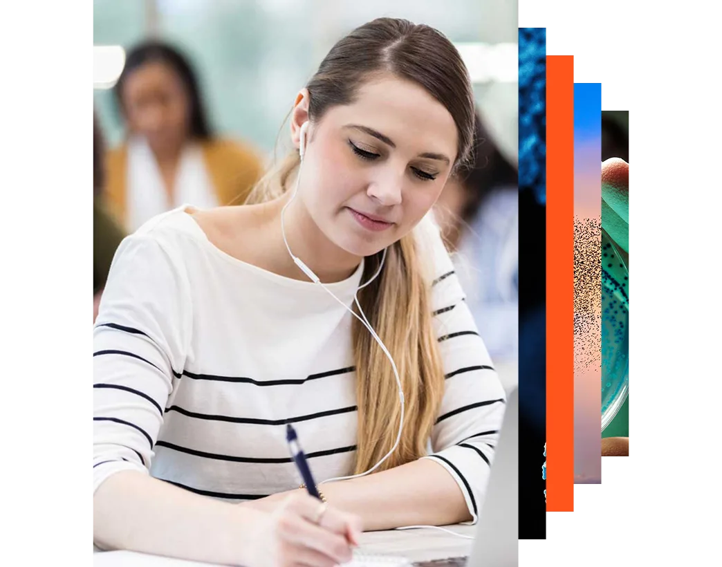 Young female student taking notes in a classroom