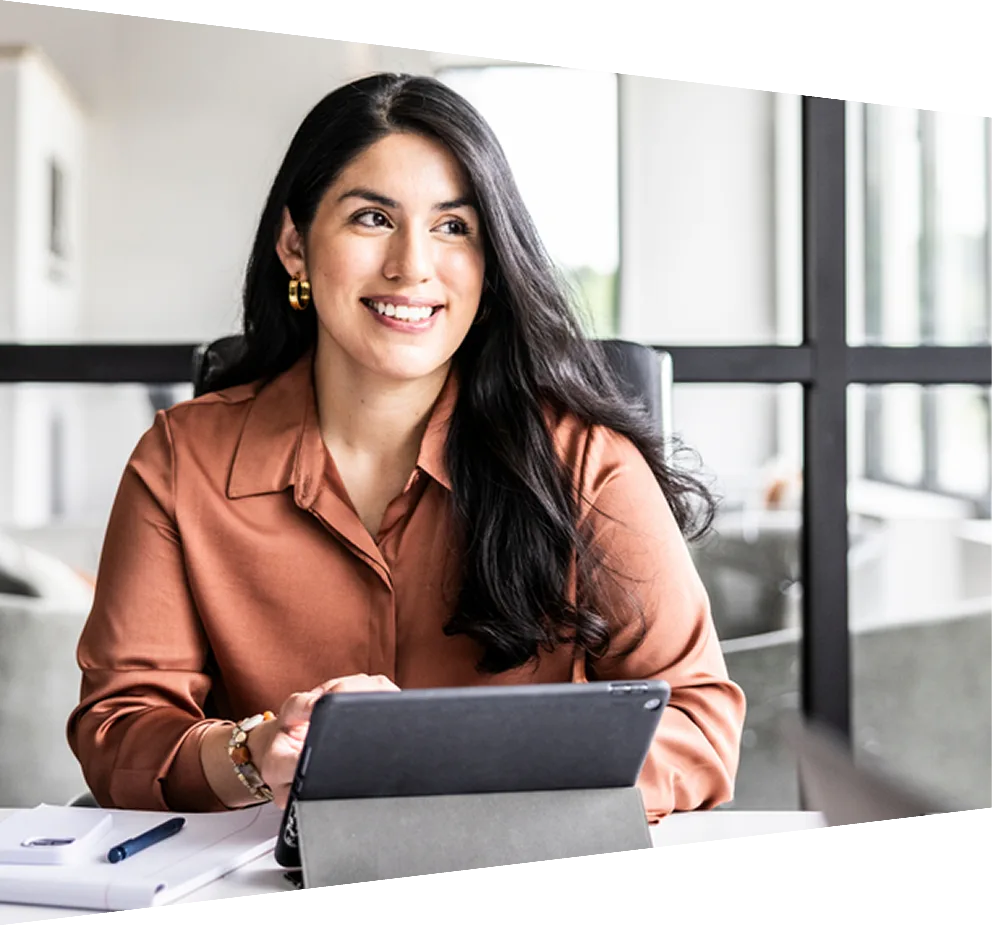 An Elsevier employee in a business suit and tie holds up her hand, making a peace sign with a confident smile.