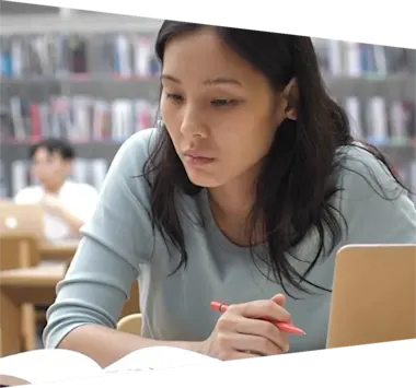 Student in a library looking at books