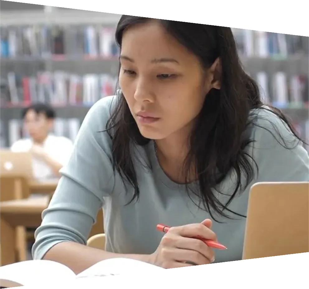 Student in a library looking at books