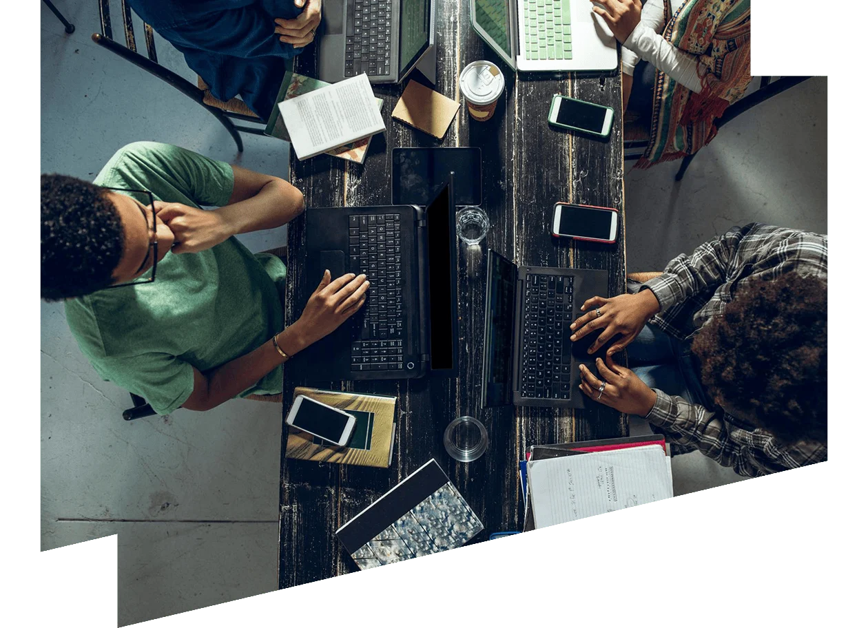View of multiple workers using laptops from above