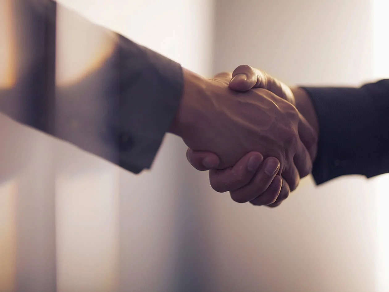 Handshake in contemporary office space