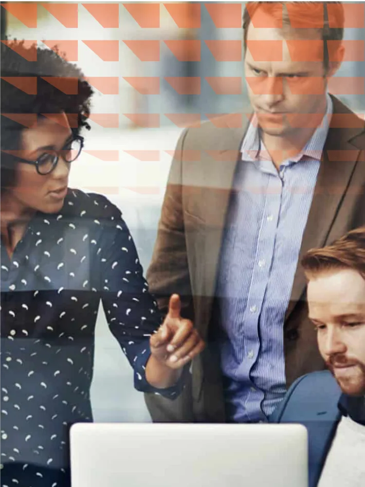A team of individuals gathered around a laptop, engaged in discussion and collaboration