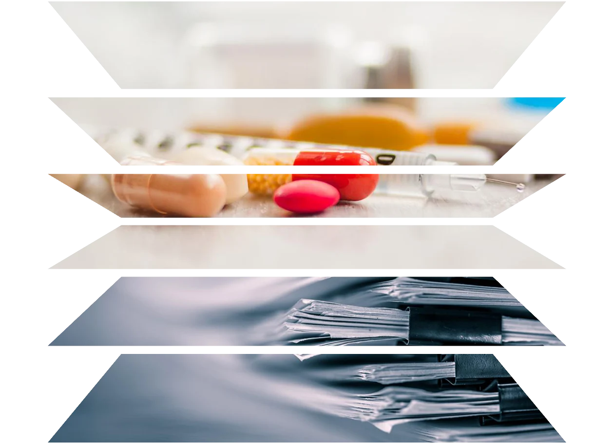 Close-up of syringe with multicolored pills and ampules of medicine and pile of documents