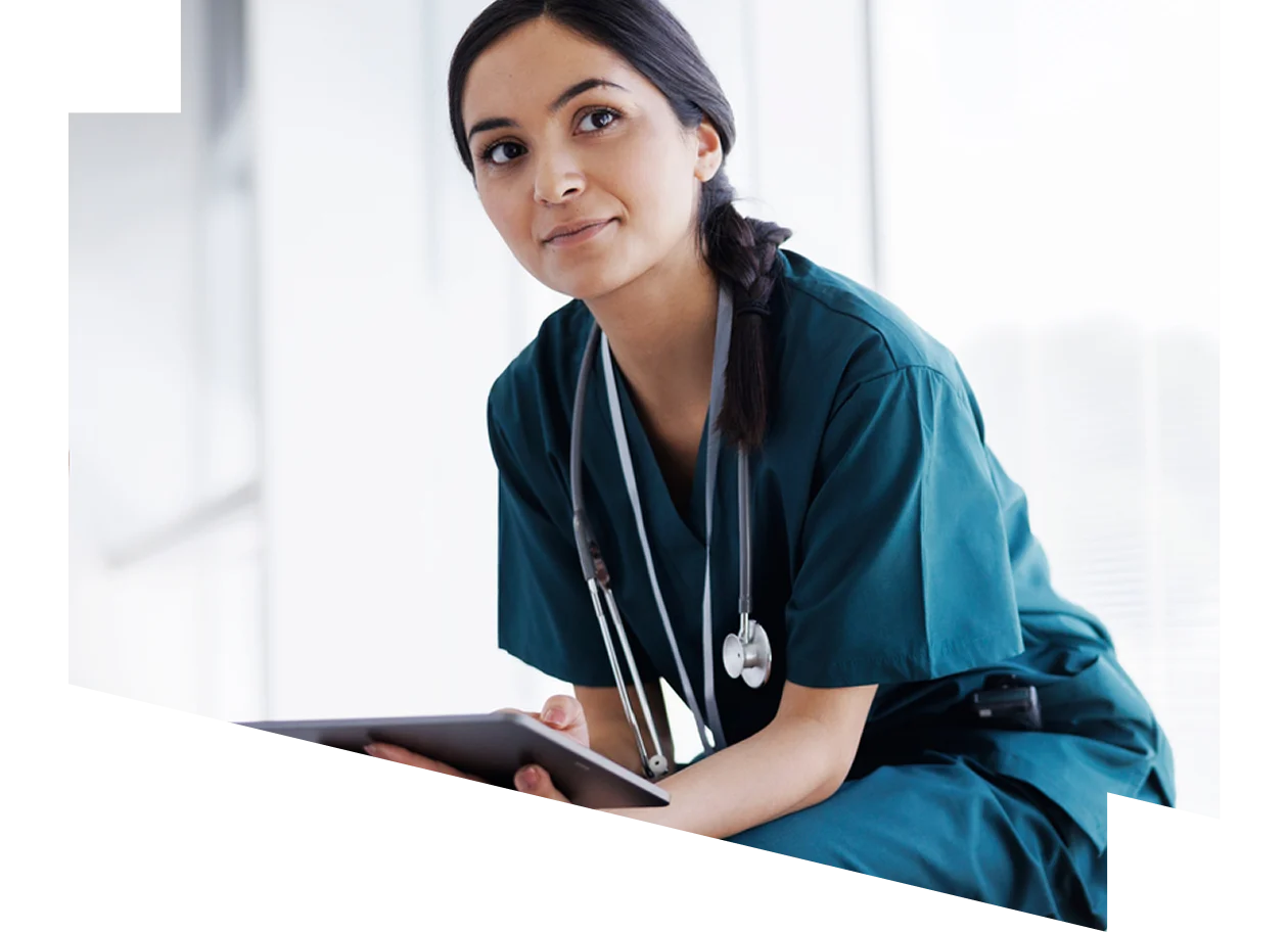 Female healthcare professional looking at a digital tablet