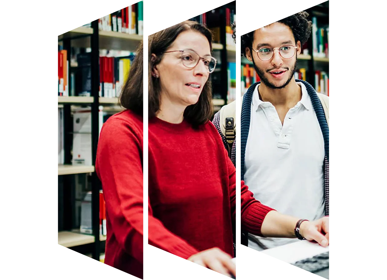 Librarian looking up books on computer for student