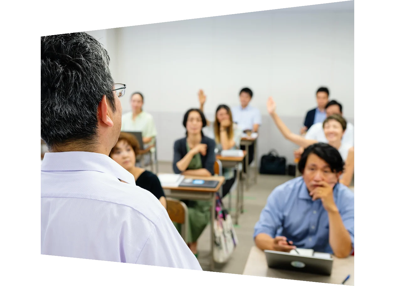 A professor in lecture hall in front of a class