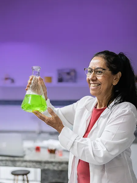 Female chemist in the lab holding a conical flask