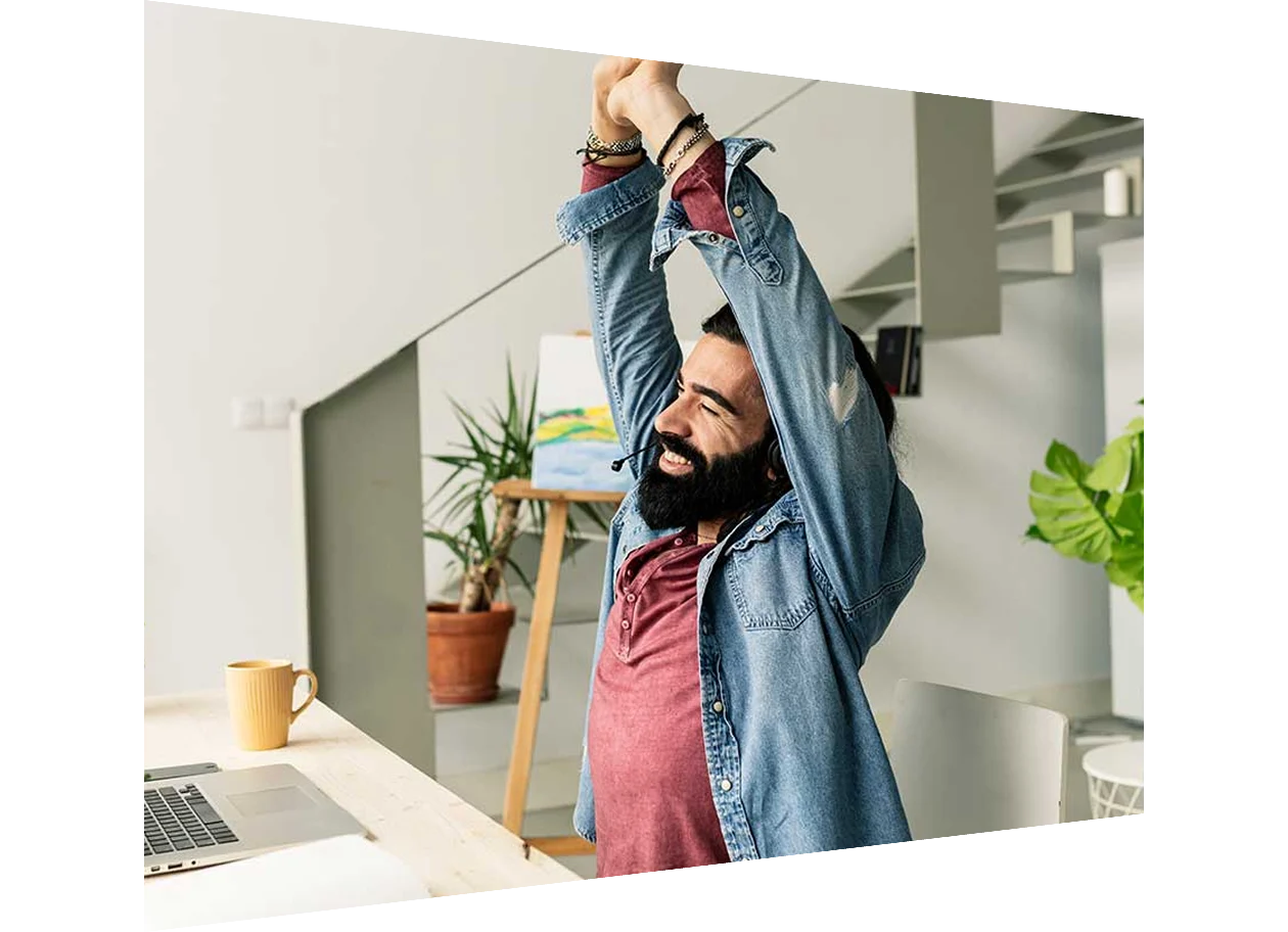 Man stretches while working