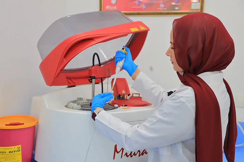 Photo of Dr Haneen Dwaib working in her lab at Palestine Ahliya University, where she is Chairwoman of the Clinical Nutrition and Dietetics department.