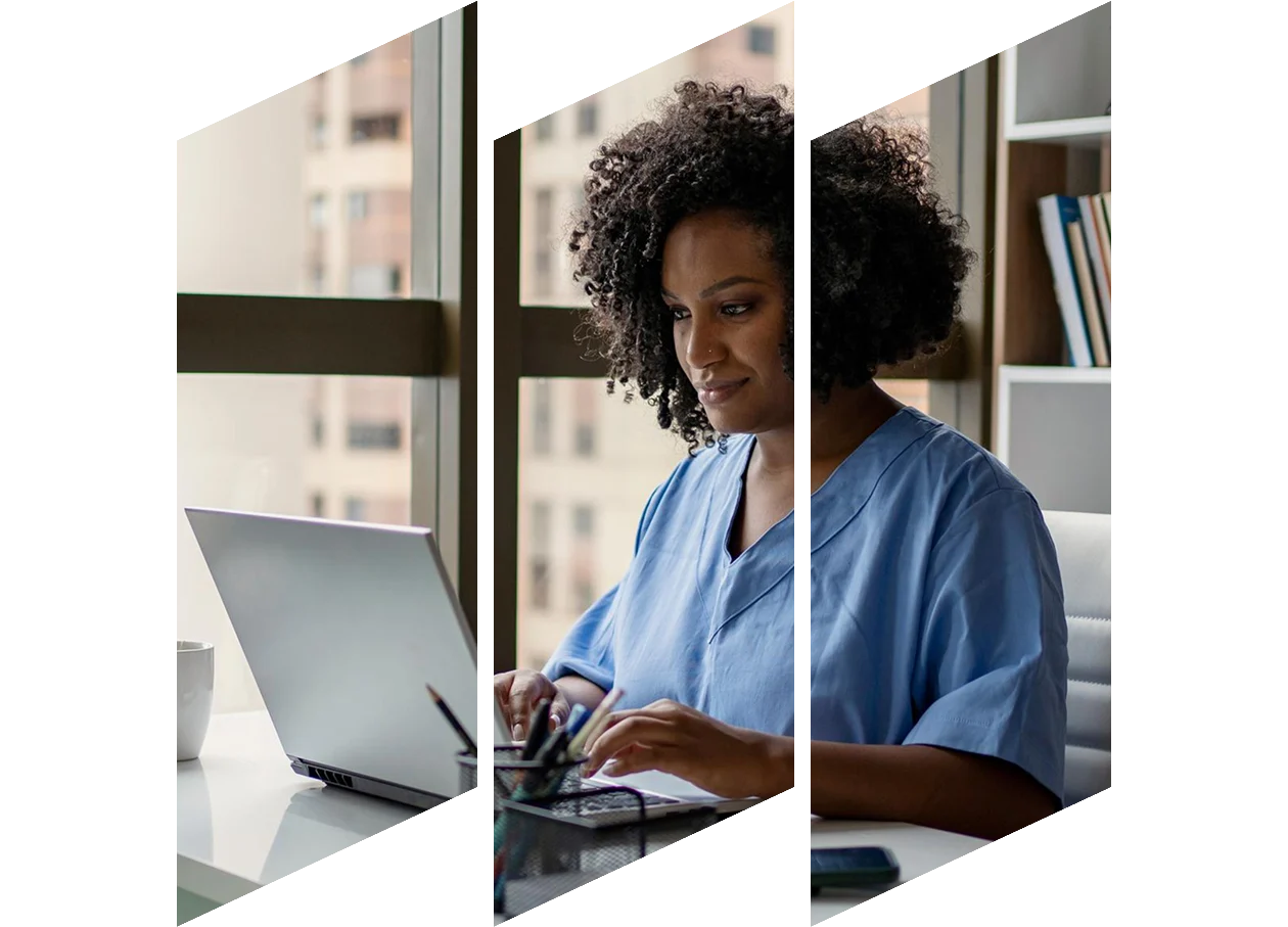 African American nurse working on laptop at her desk