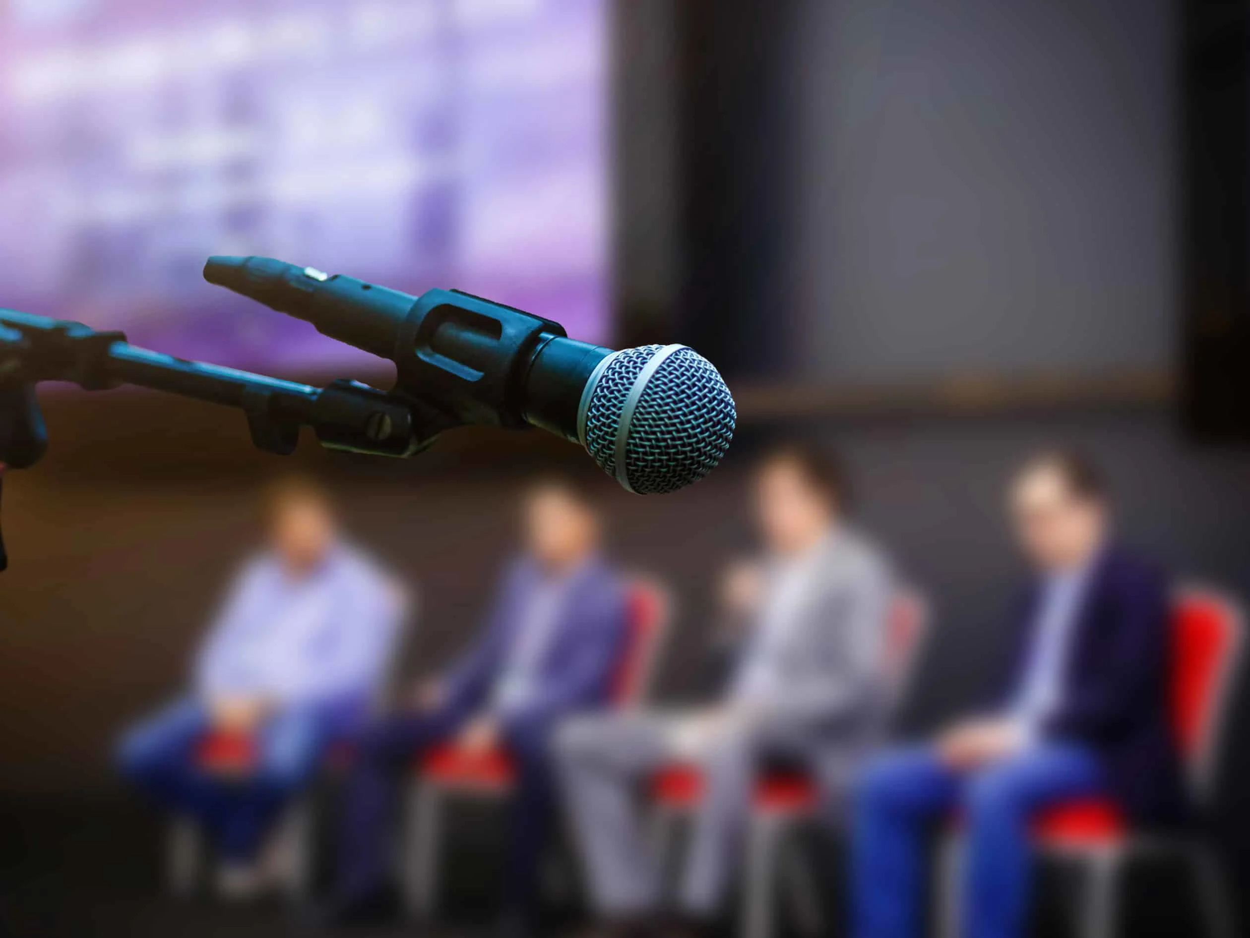 Microphone in front of business people at conference