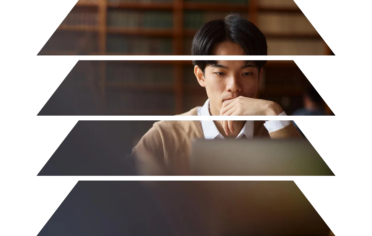 Student sitting in library using a tablet