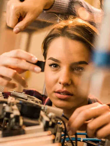 Young scientist examining a test machine