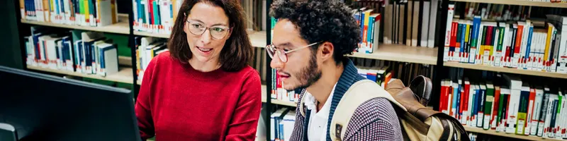 A librarian helping a student