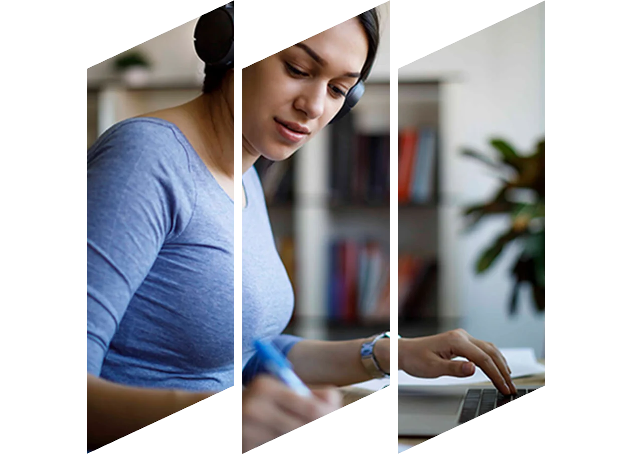 Young female studying on laptop taking notes