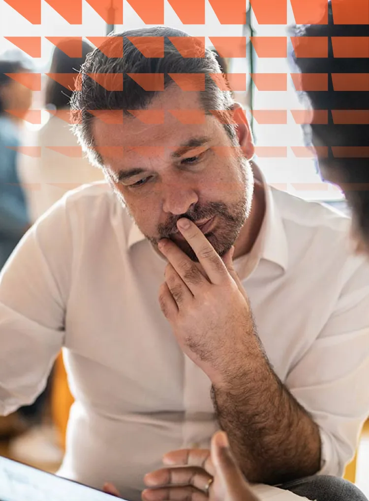 Man looking at digital tablet with colleague