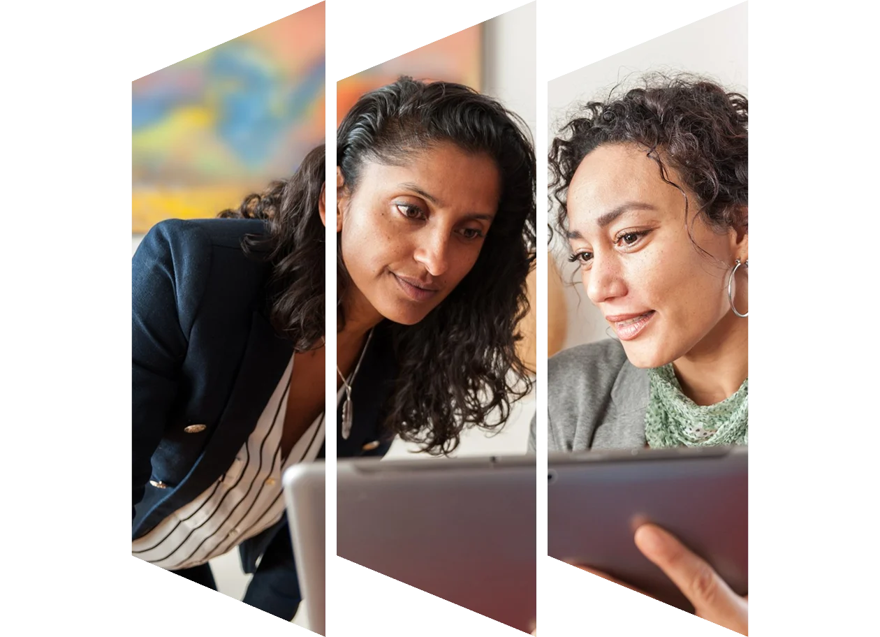Two business women looking at a tablet computer, discussing a topic
