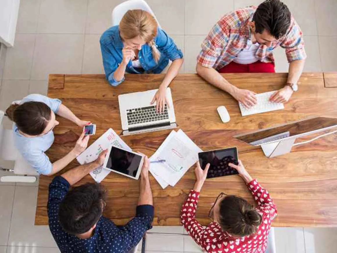 colleagues working on projects around table