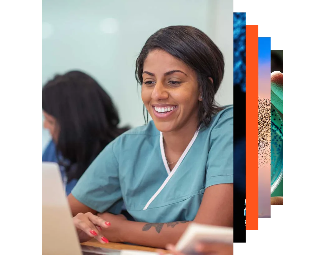 Smiling young health professional looking at a laptop