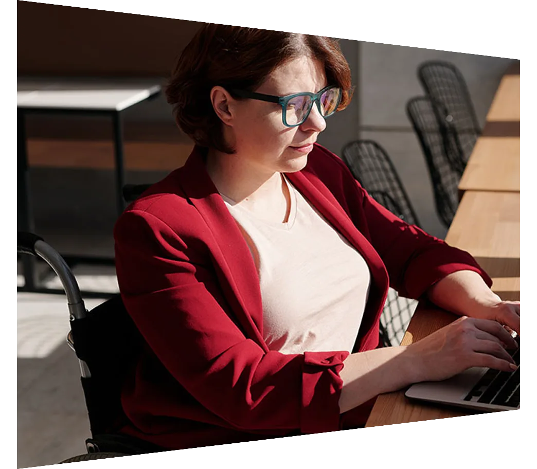 Woman in wheelchair working on laptop