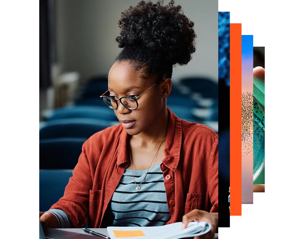 Young African American woman using laptop while studying at university classroom