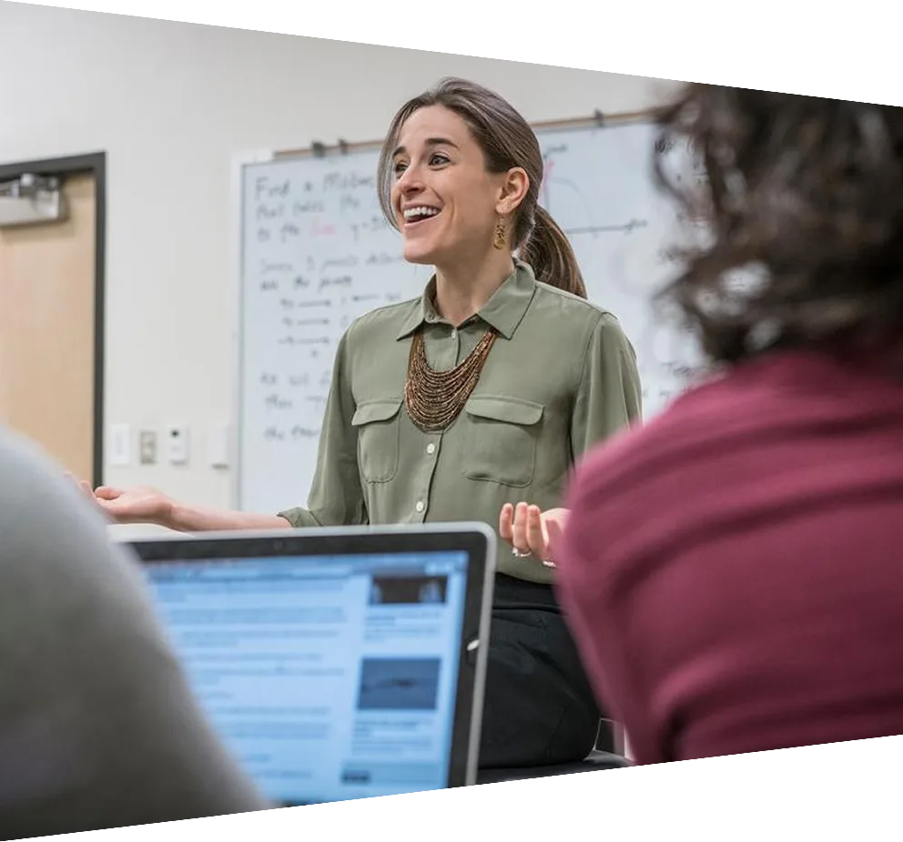 Professor talking to students in college classroom