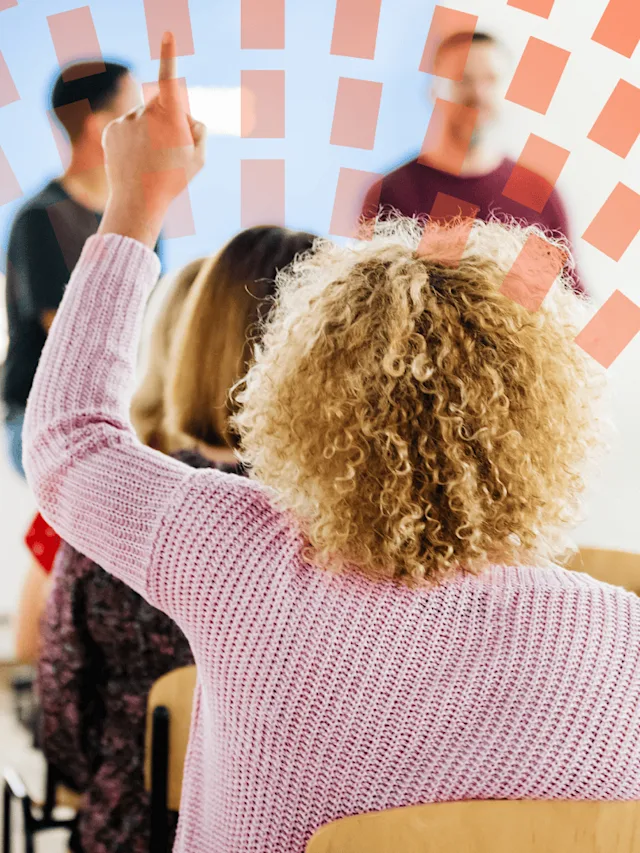 Woman raising hand to ask question during presentation