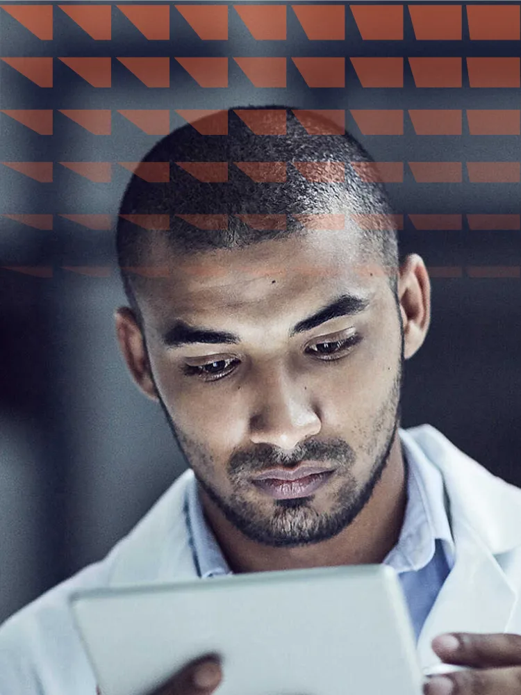 Researcher looking a digital tablet in lab