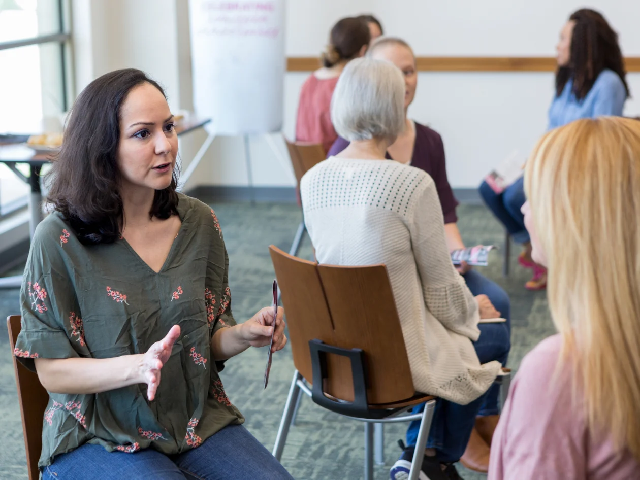 Two woman facing each other in discussion.