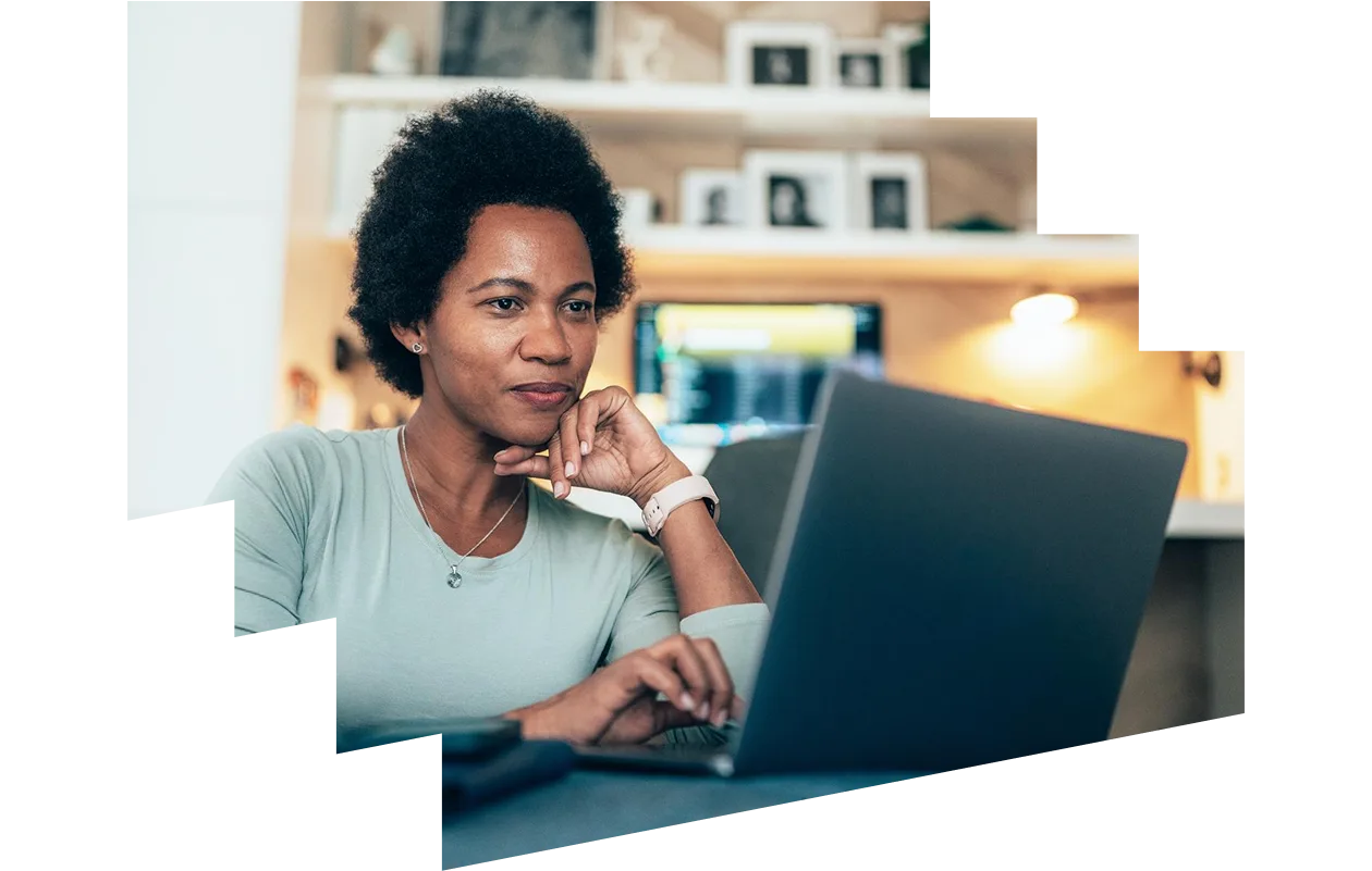 Afro-american woman using her laptop at home
