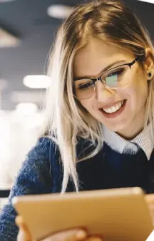 Smiling student looking at a tablet