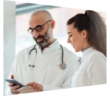 Two doctors looking at iphone