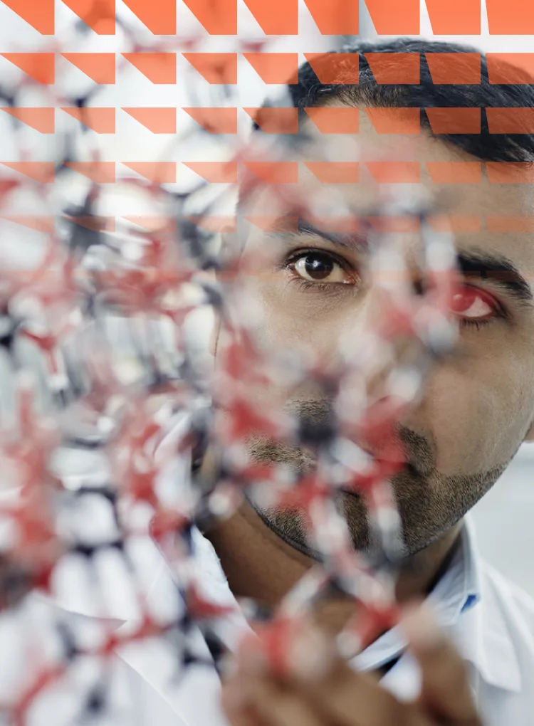 Close-up of man holding chemistry molecule plastic model