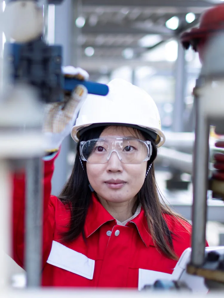 Female Chinese engineer working in manufacturing plant