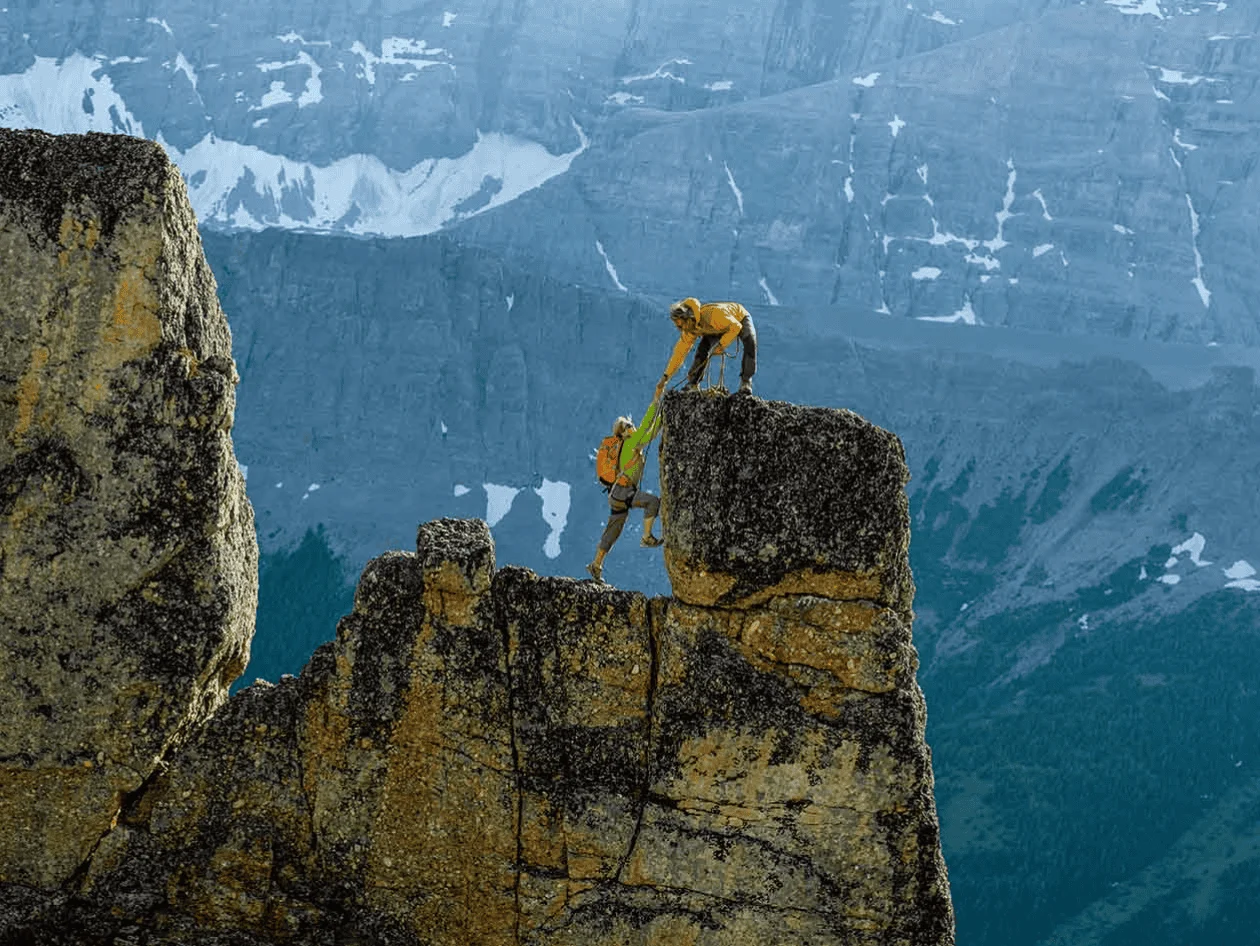 two climbers reaching summit