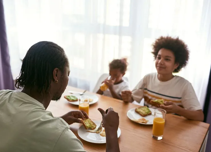 Father and children eating together