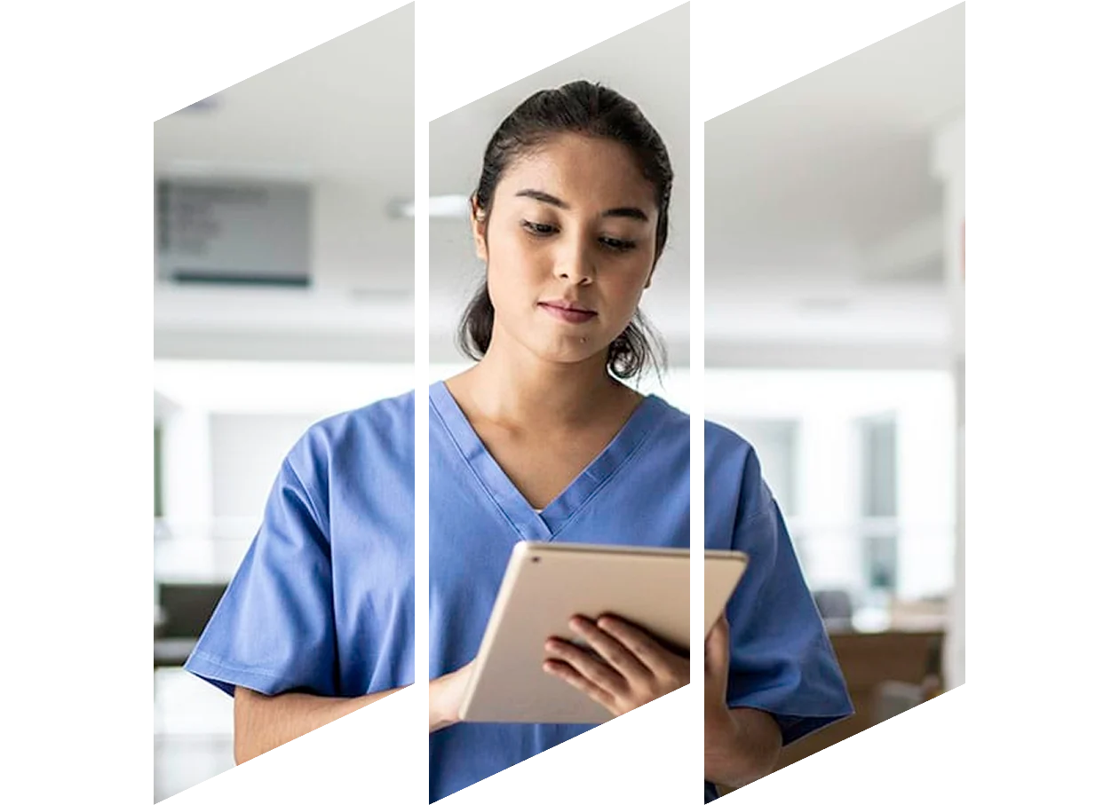 Young female nurse in scrubs reviewing information on a tablet