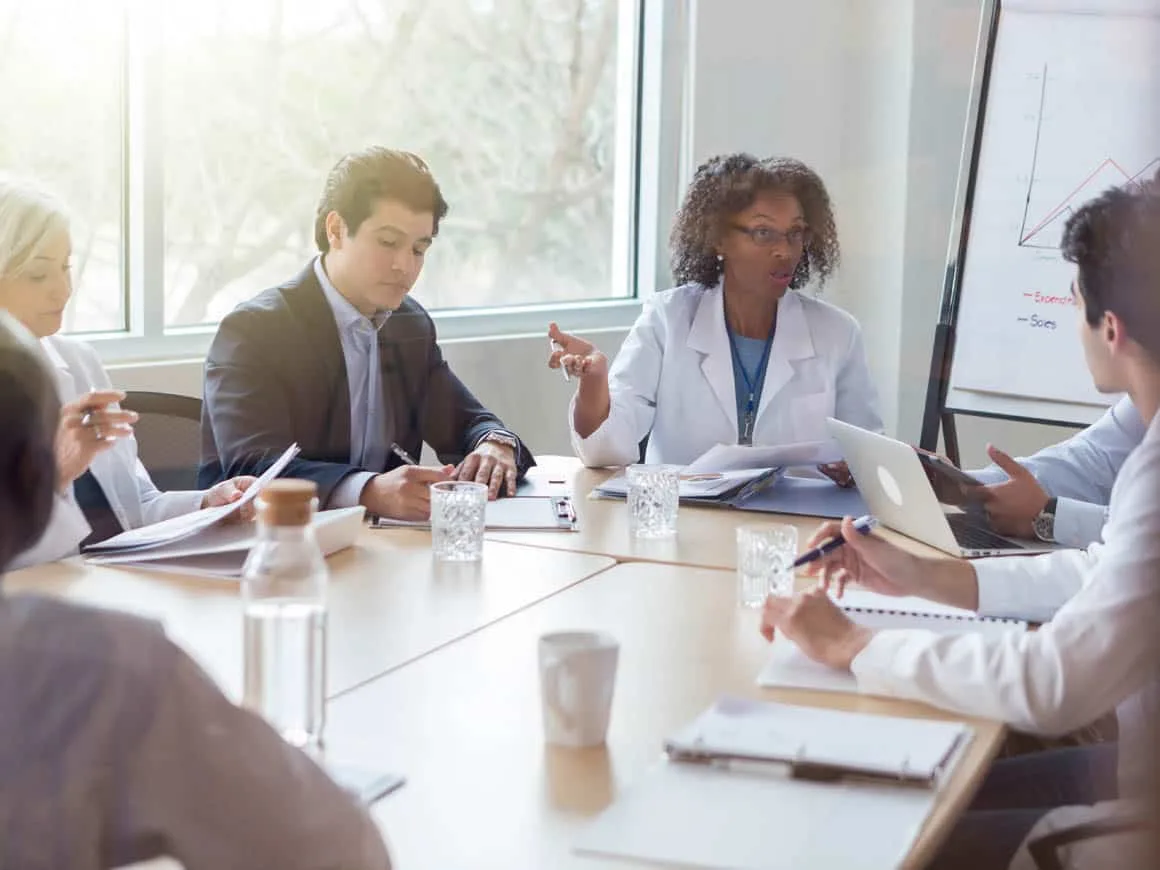 Female doctor participates in meeting with hospital administration