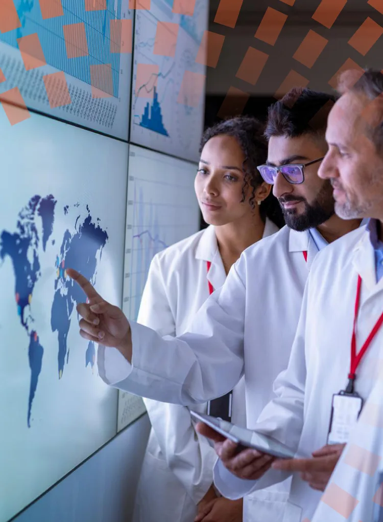 Team of researchers and clinicians looking at data on a large digital screen