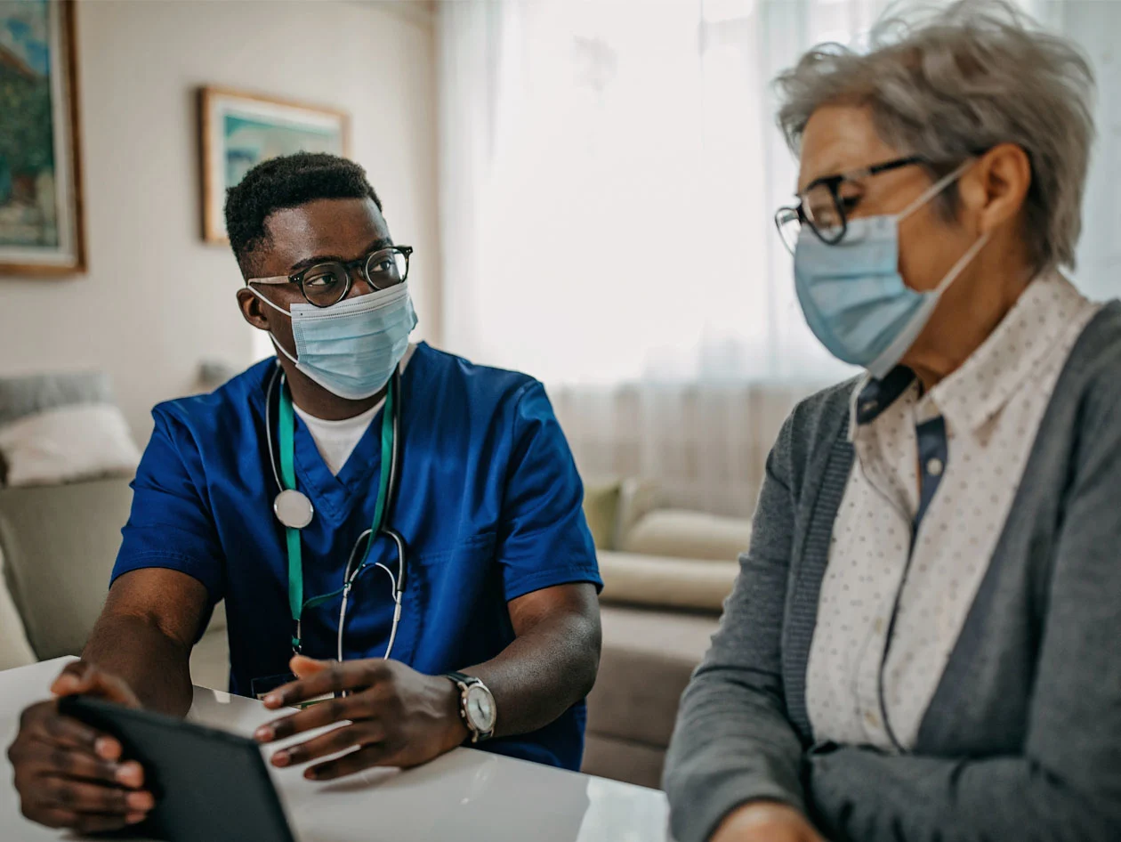 Doctor explaining to patient how to use telemedicine