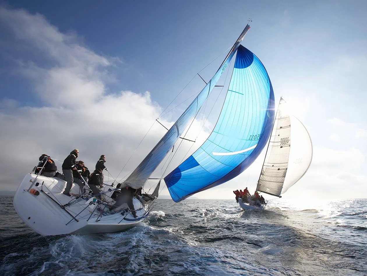 group of sailors on a boat braving the waves