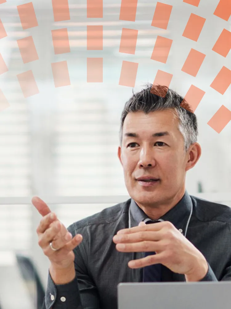 Manager talking to his colleagues in a meeting in the office