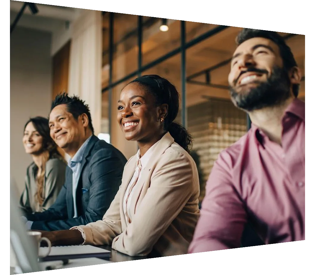 Smiling multiracial male and female colleagues during meeting
