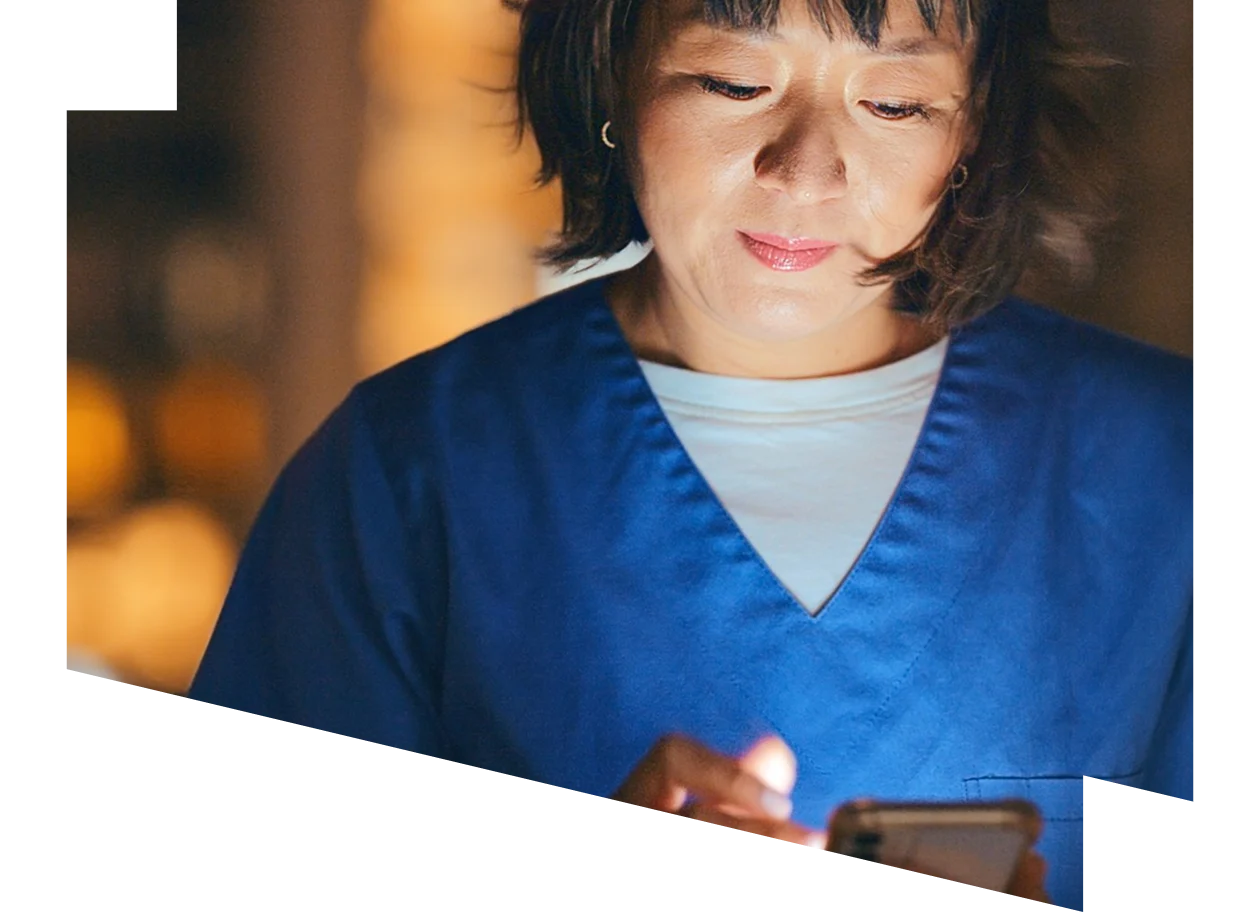 Female healthcare professional looking at a digital tablet